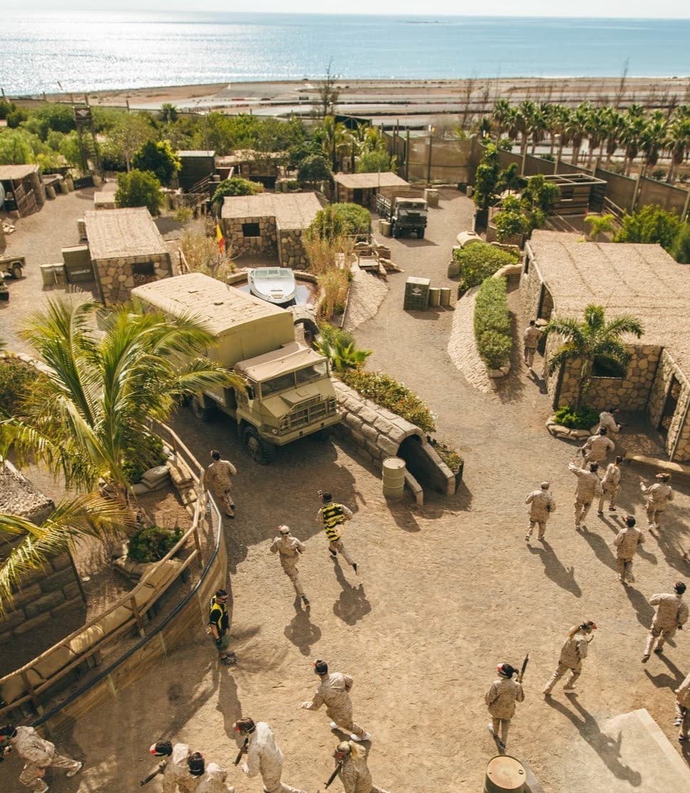 Campo de airsoft con estructuras militares y vegetación